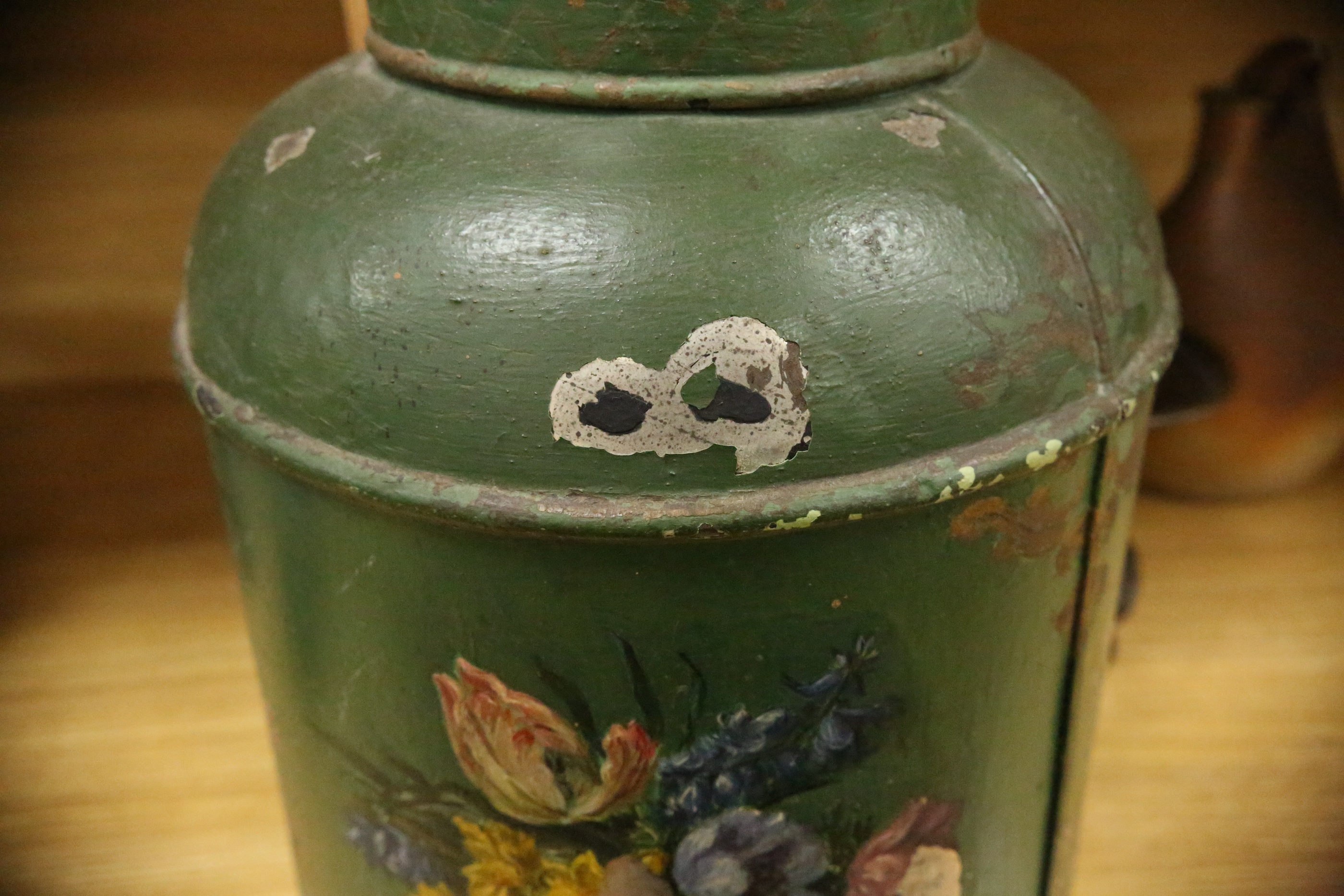 A green toleware floral decorated tea canister, 42cm high. Condition - poor, many chips to surface paint